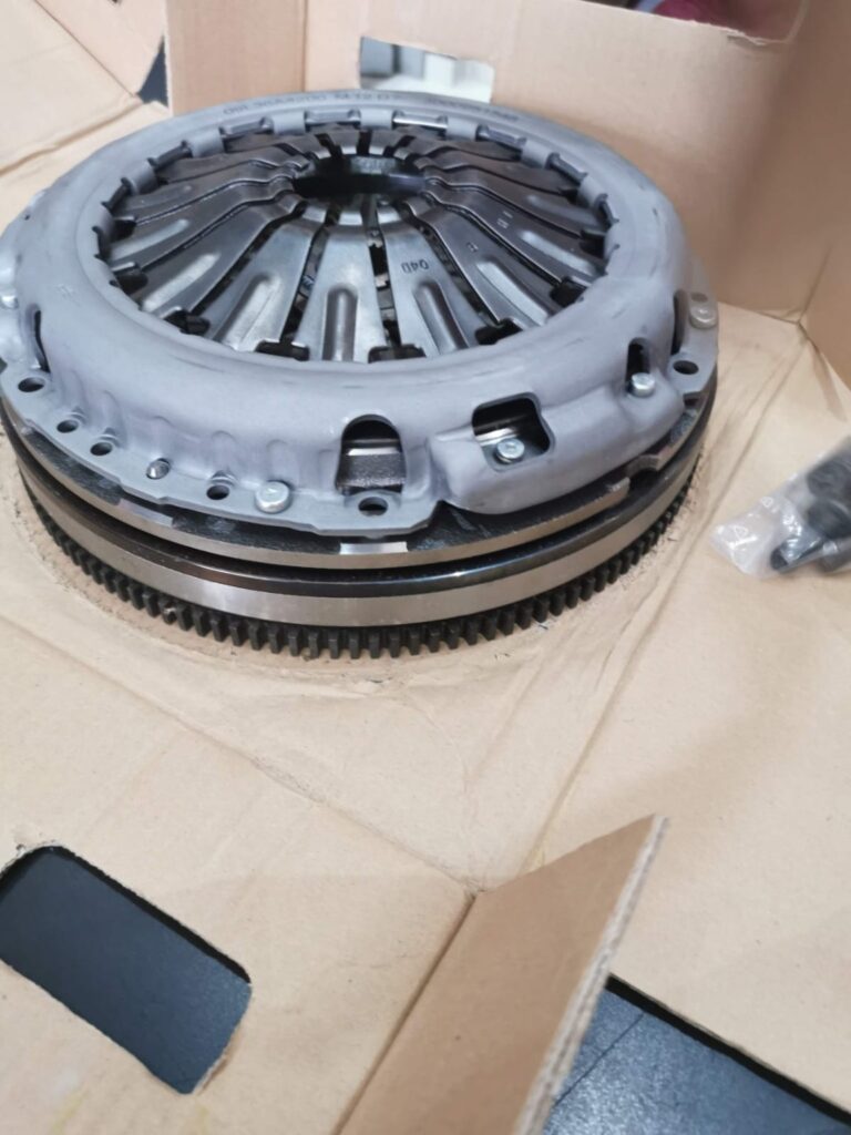 Clutch assembly resting in a cardboard parts box