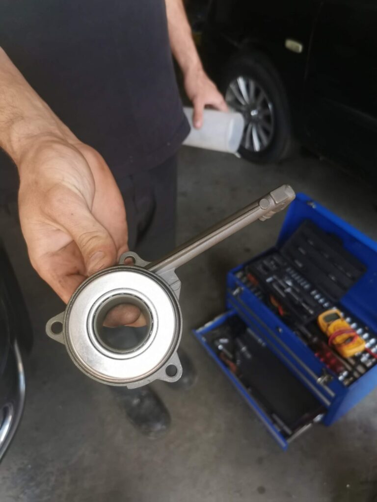 Clutch release component held beside a tool trolley